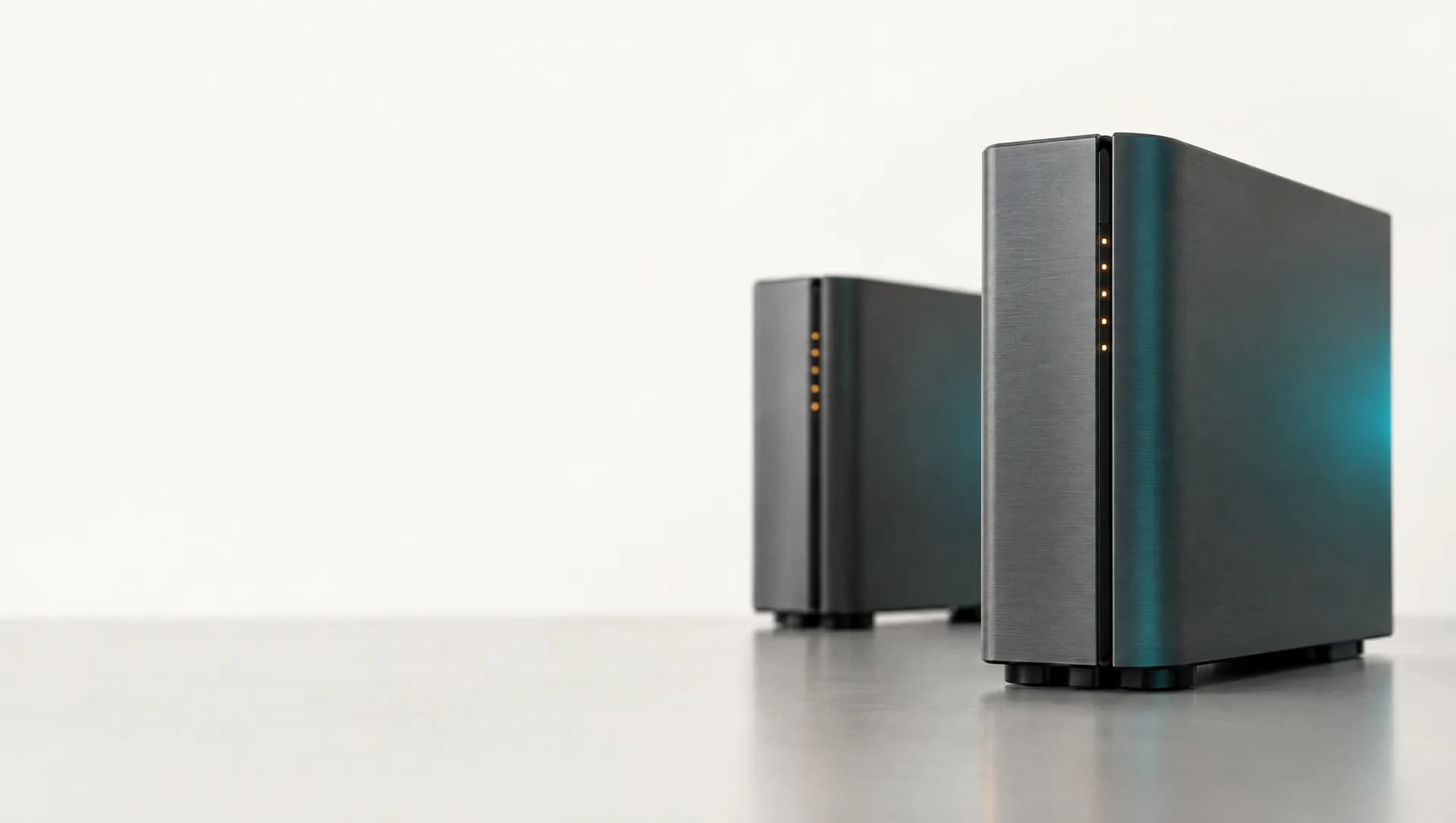 Two brushed-metal server towers with a row of amber status lights